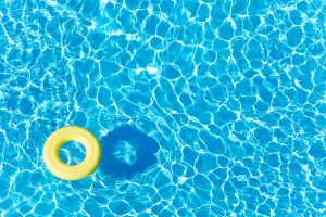 Empty,Rubber,Ring,Floating,On,Blue,Water,Surface